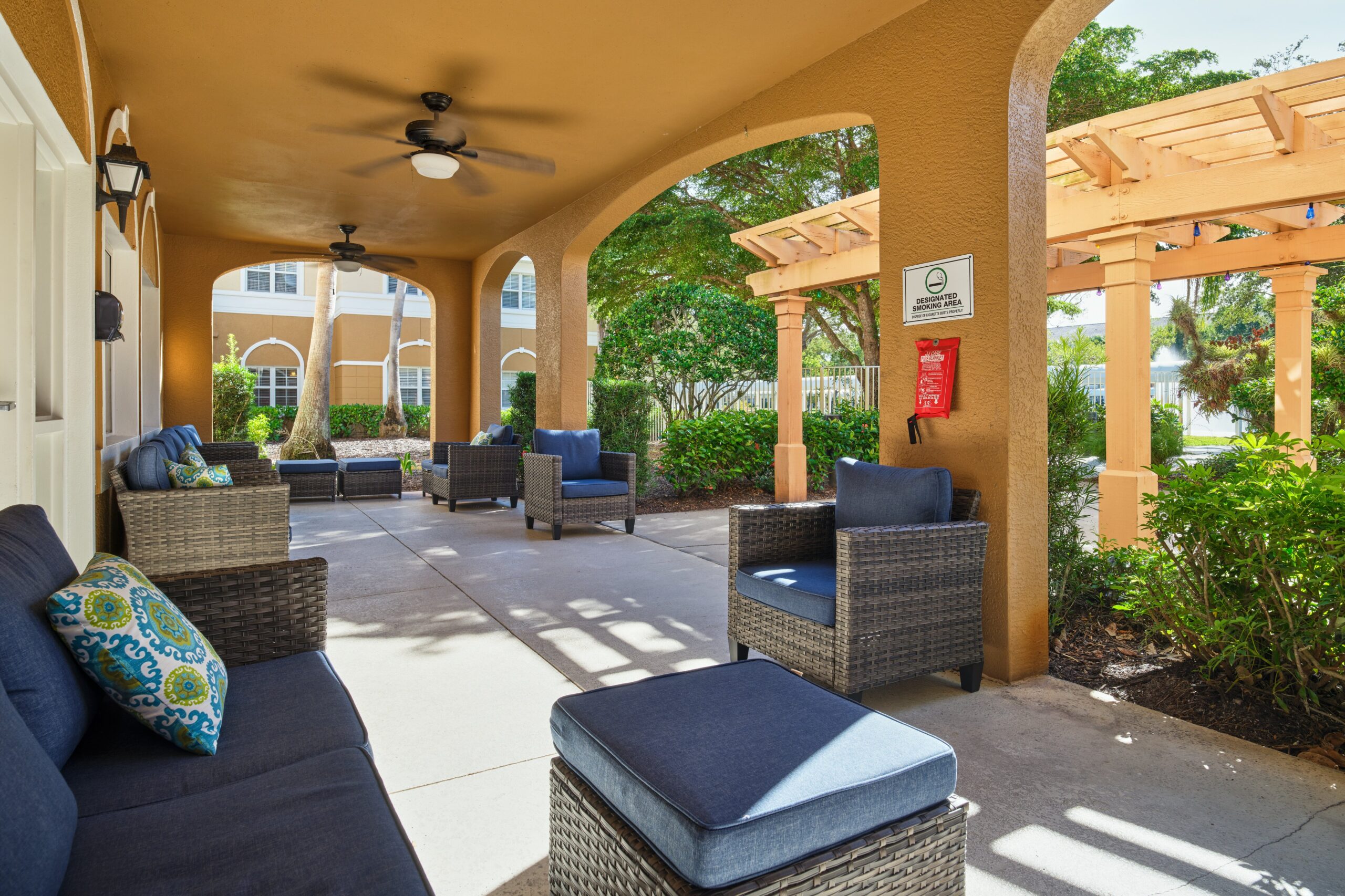 Outdoor seating area with wicker furniture and greenery