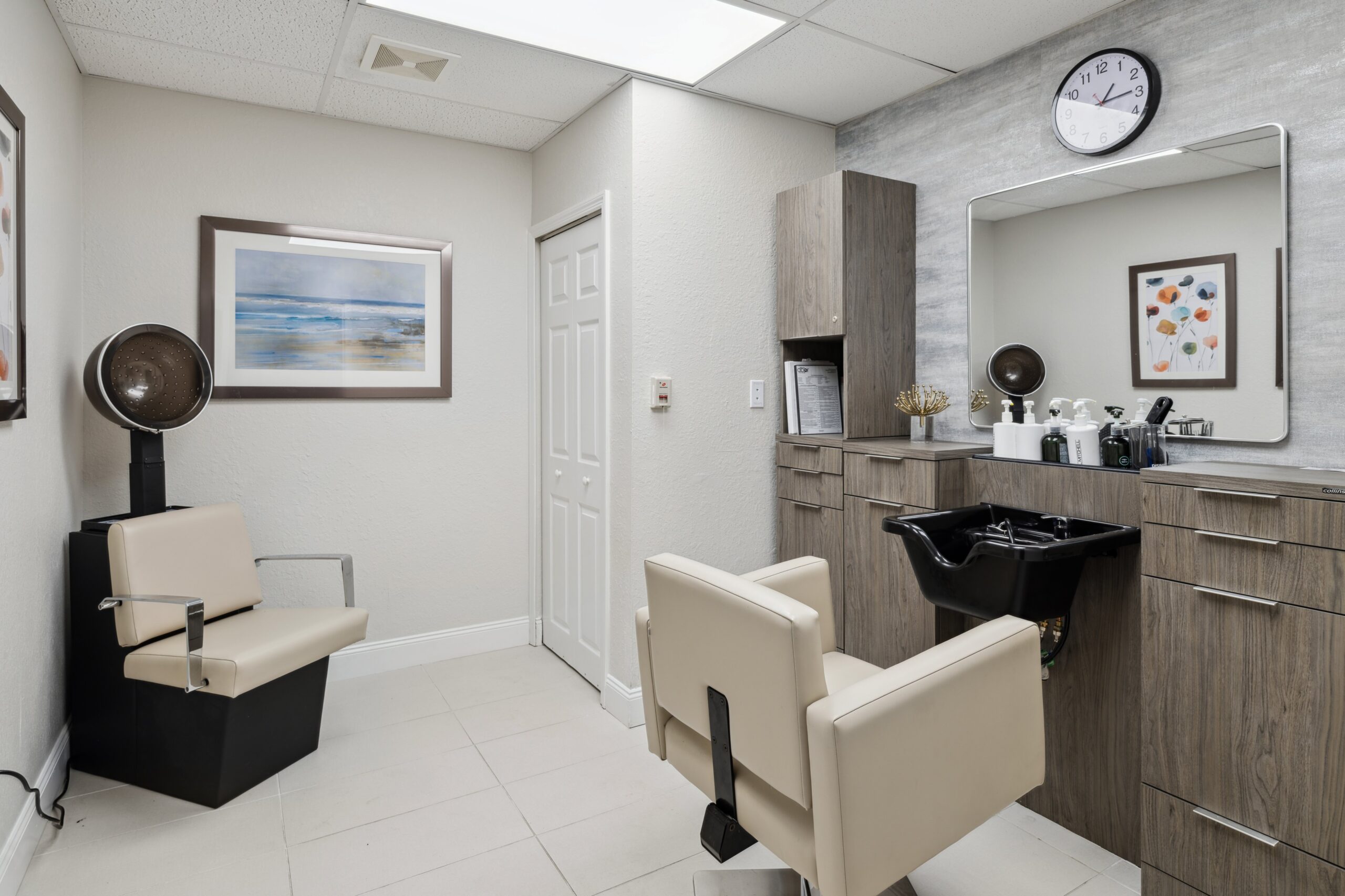 Modern hair salon area with styling chairs and equipment