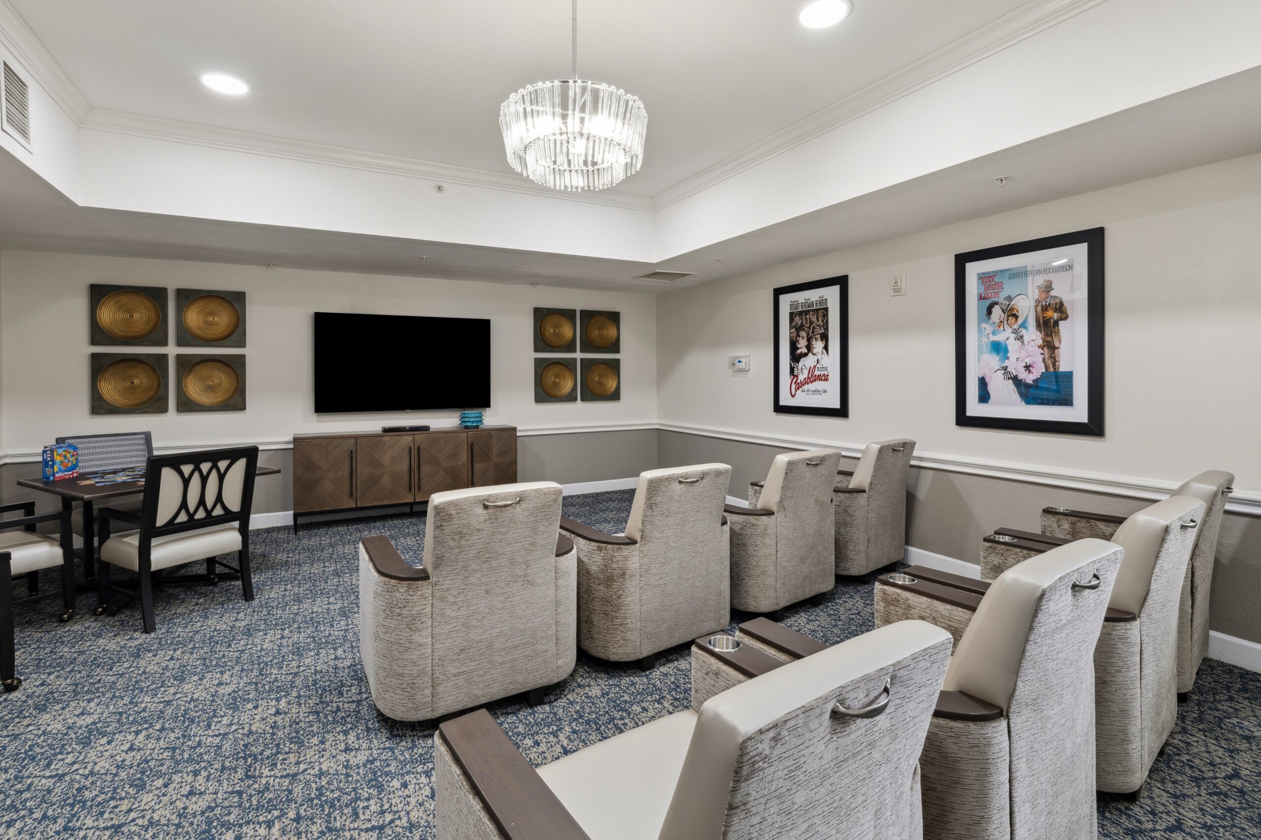 A cozy interior common area with seating and TV