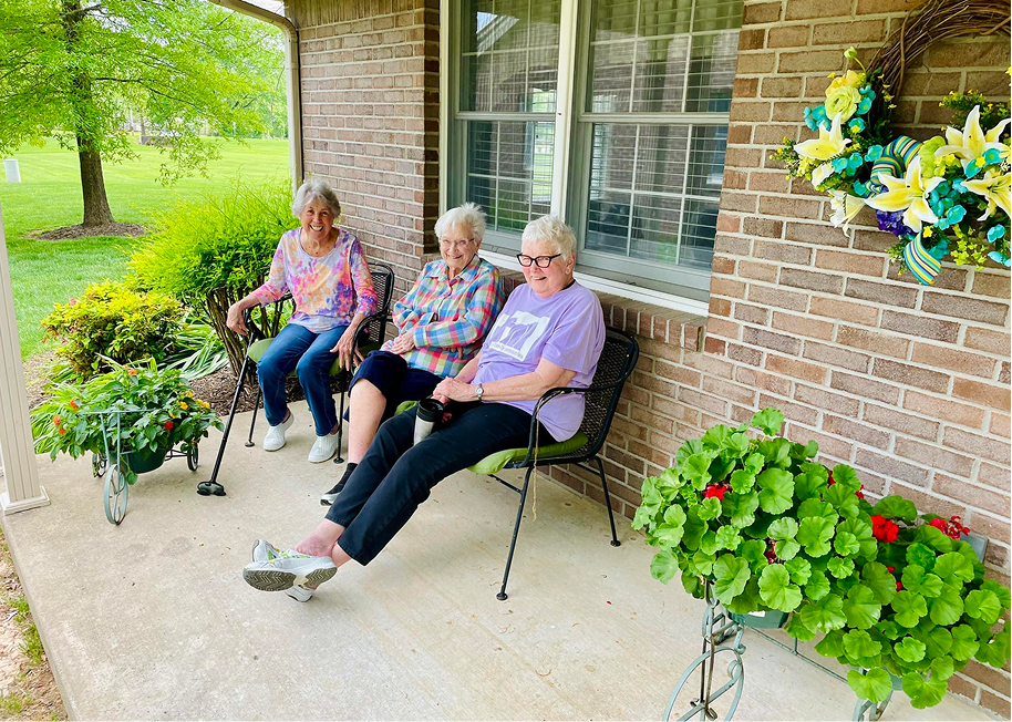 Three residents enjoying the outdoors on a porch