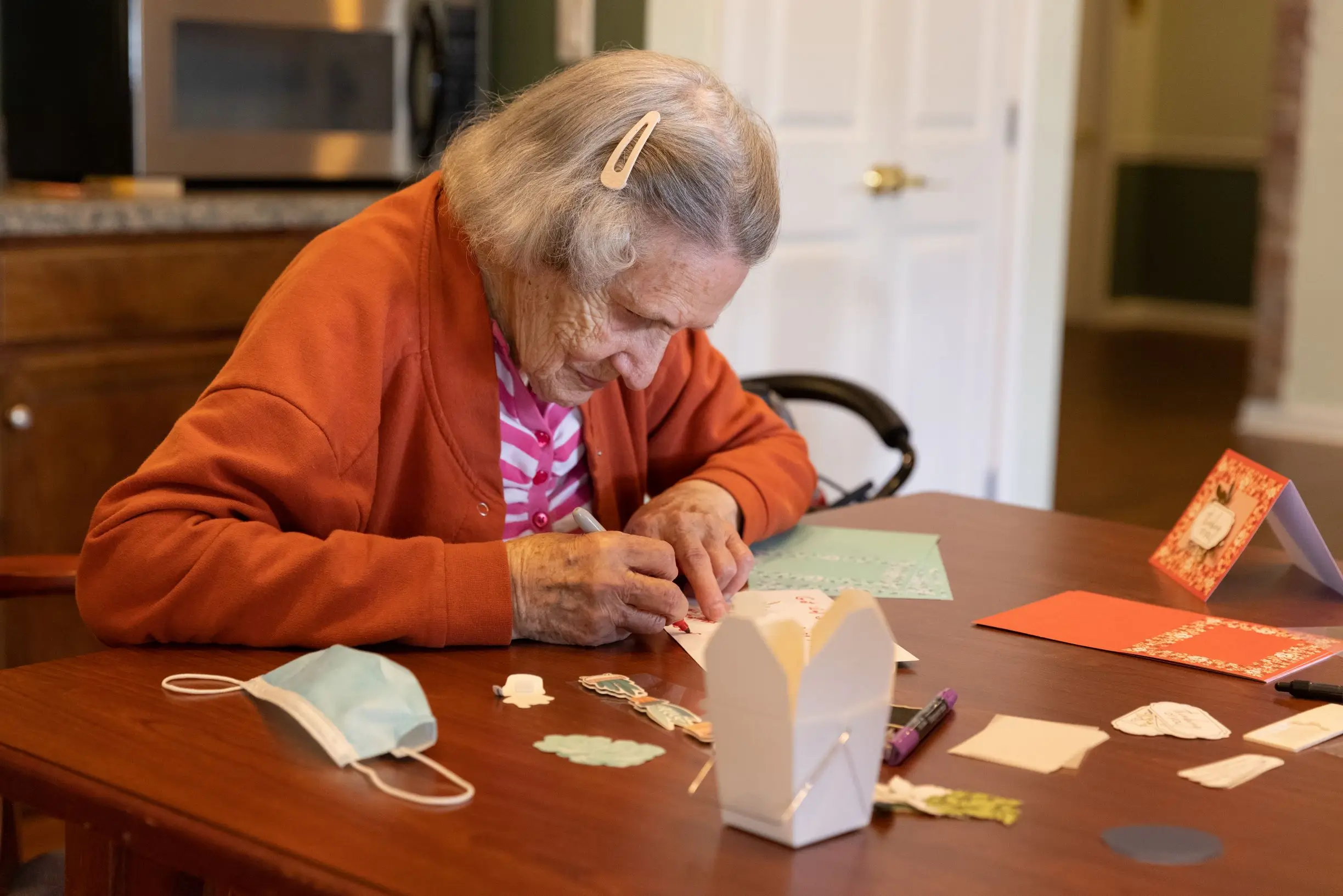 Resident engaged in a crafting activity at a table