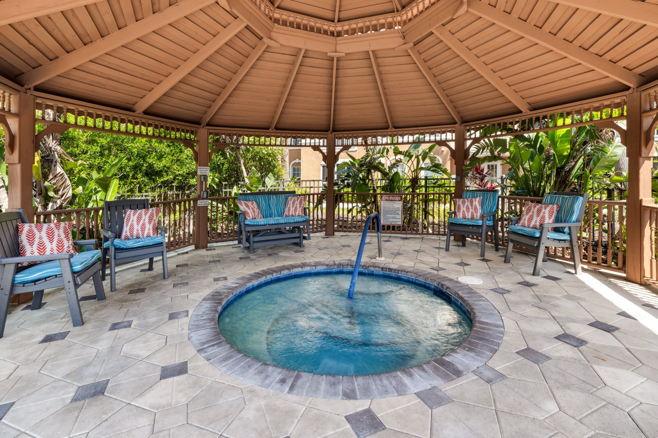 Cozy gazebo with a hot tub and seating