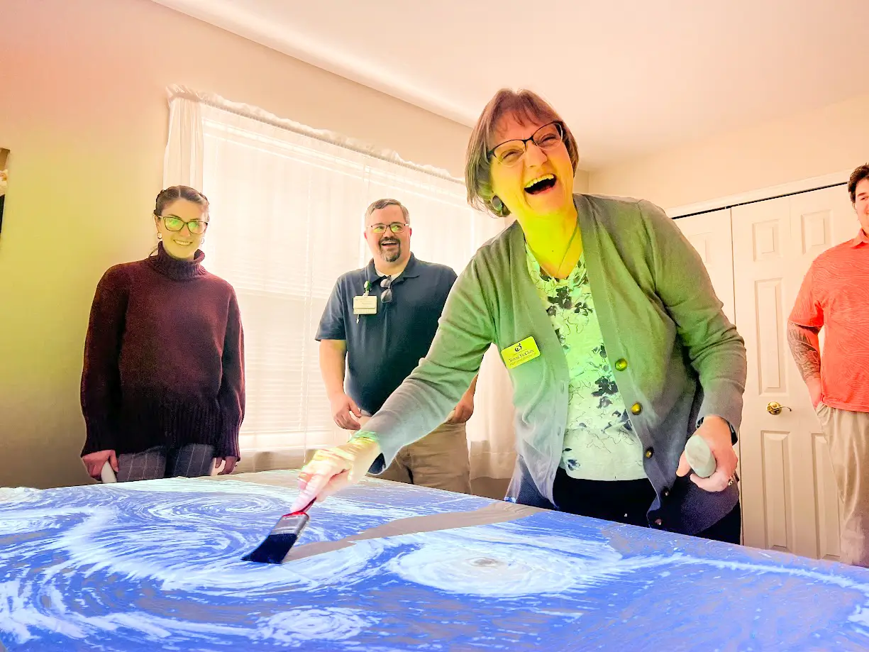Staff engaging with residents in an activity