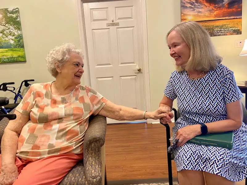Two residents enjoying a moment in a cozy common area