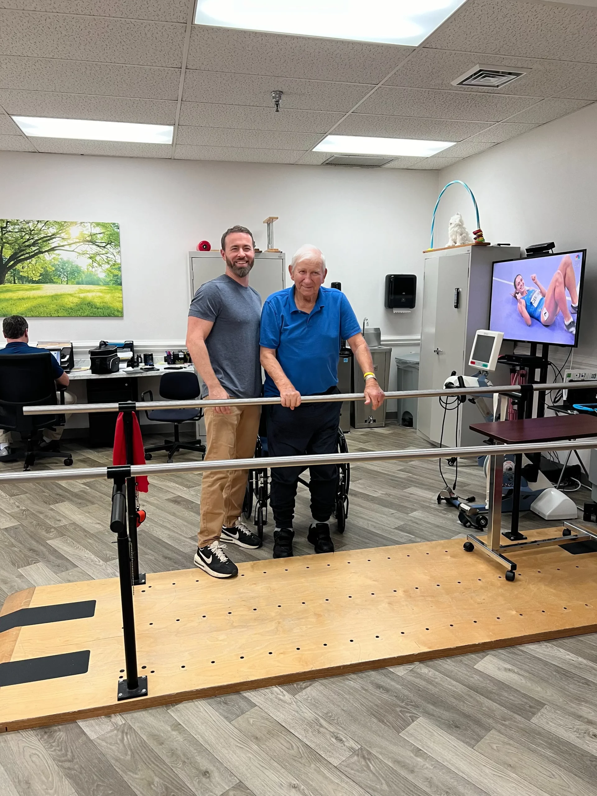Therapist assisting a resident in physical therapy