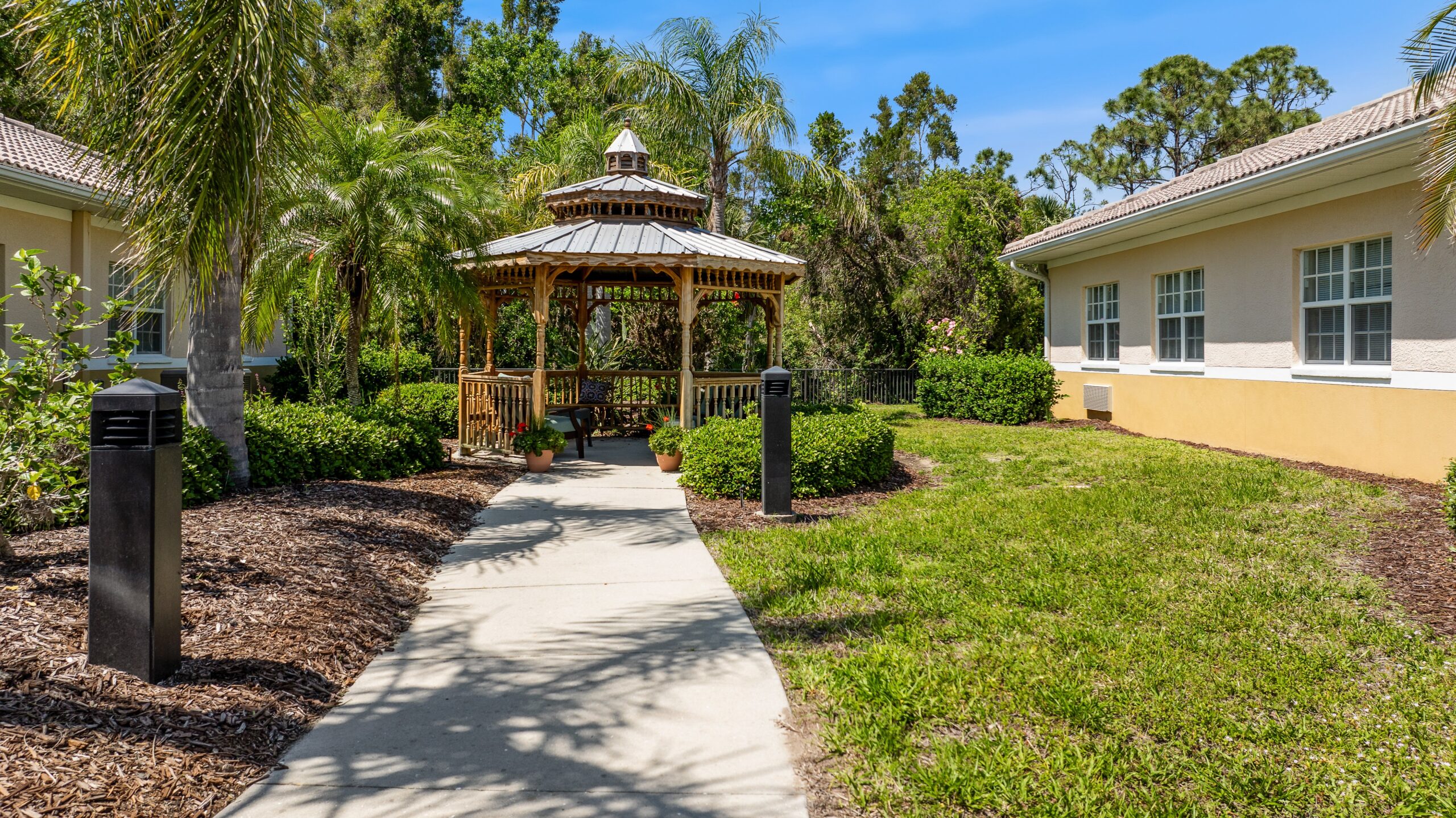 Pathway leading to a gazebo in landscaped garden