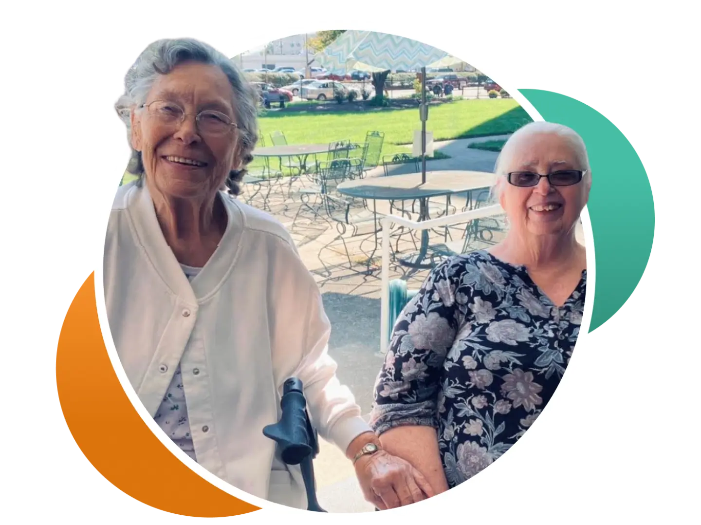 Two smiling residents enjoying the outdoor seating area