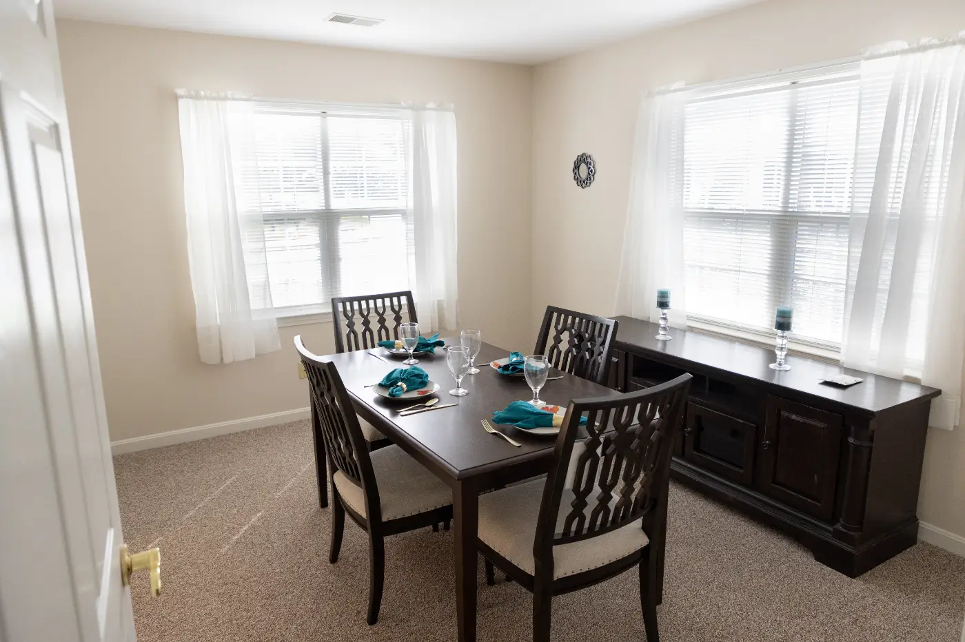 Dining area set for a meal with table and chairs