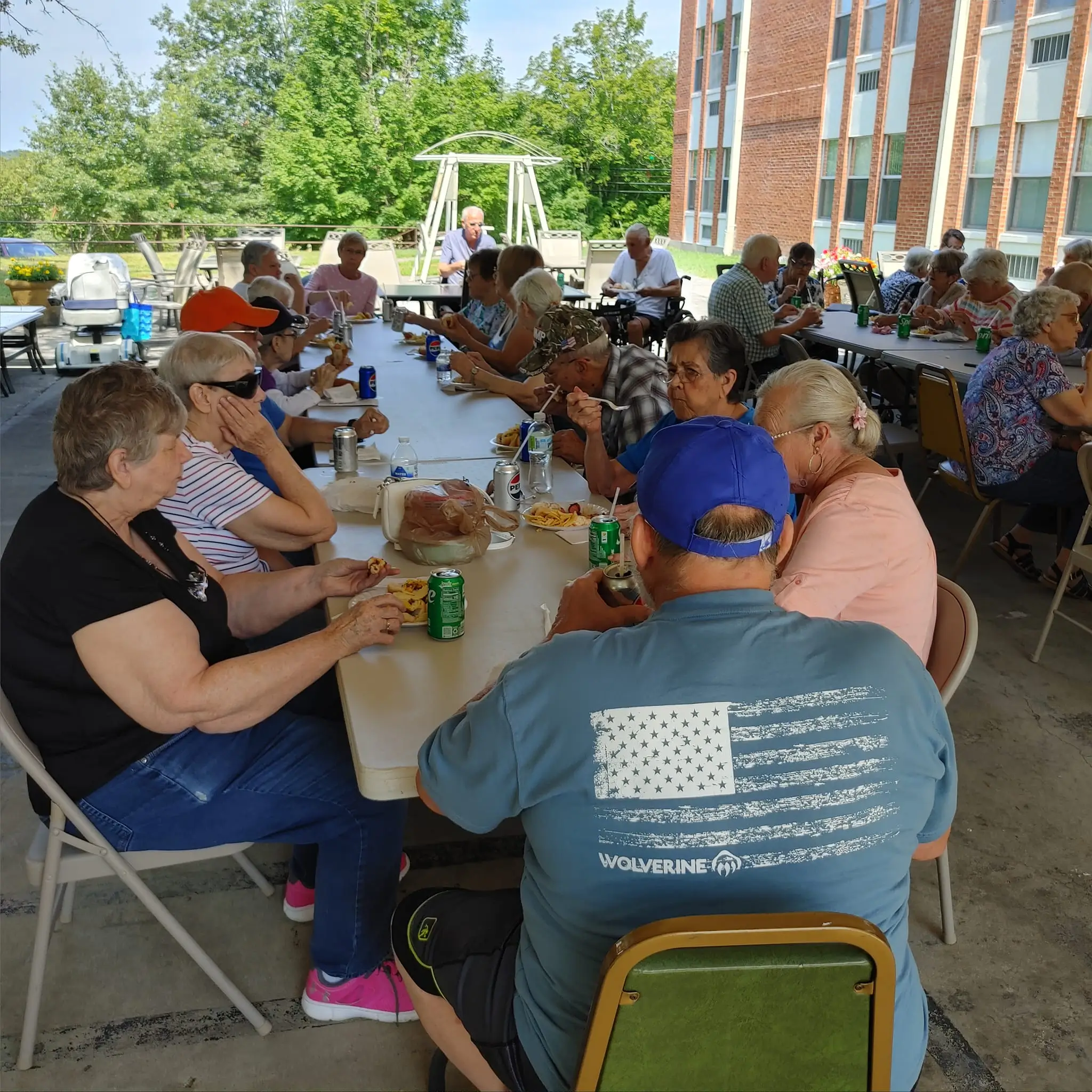 Residents enjoying a meal outdoors at a community gathering