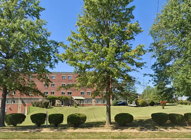 Exterior view of the assisted living facility with trees