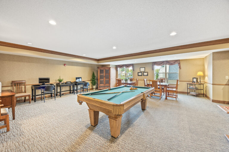 Bright common area with a pool table and seating