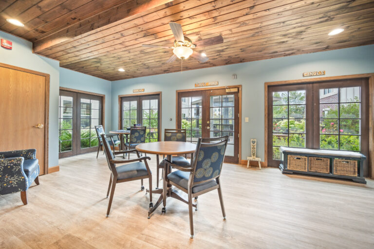 Bright common area with seating and large windows