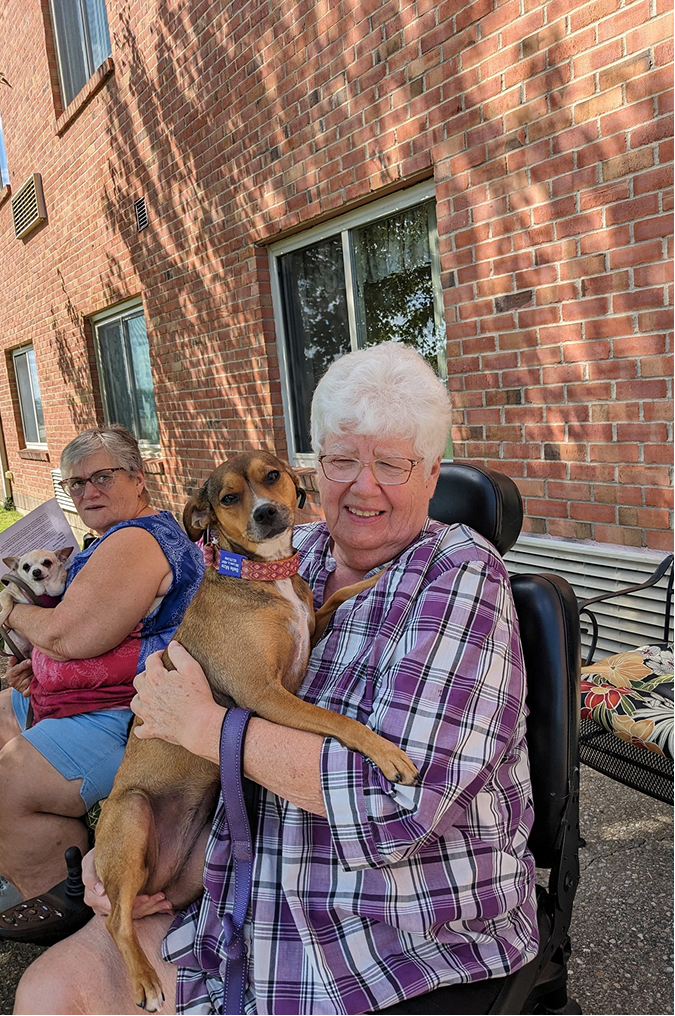 Resident enjoying time outdoors with a dog