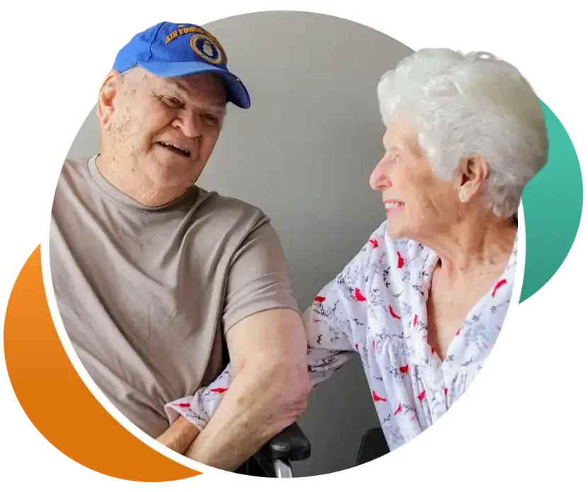 Two residents smiling during a conversation