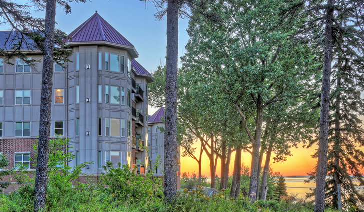 Modern assisted living facility exterior at sunset