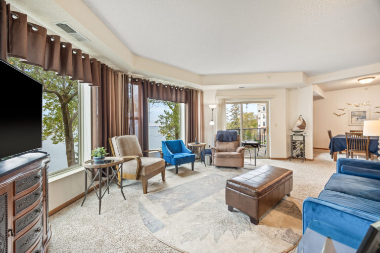 A bright common area with comfortable seating and lake view