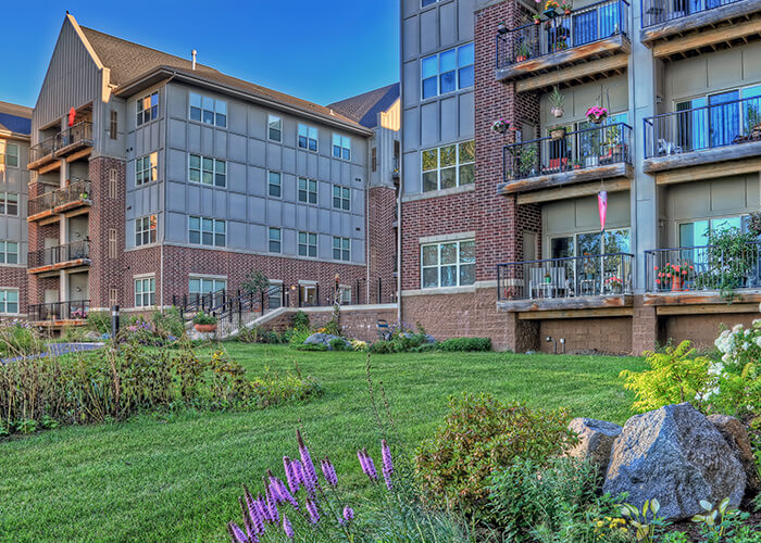 Exterior view of the facility with gardens and balconies