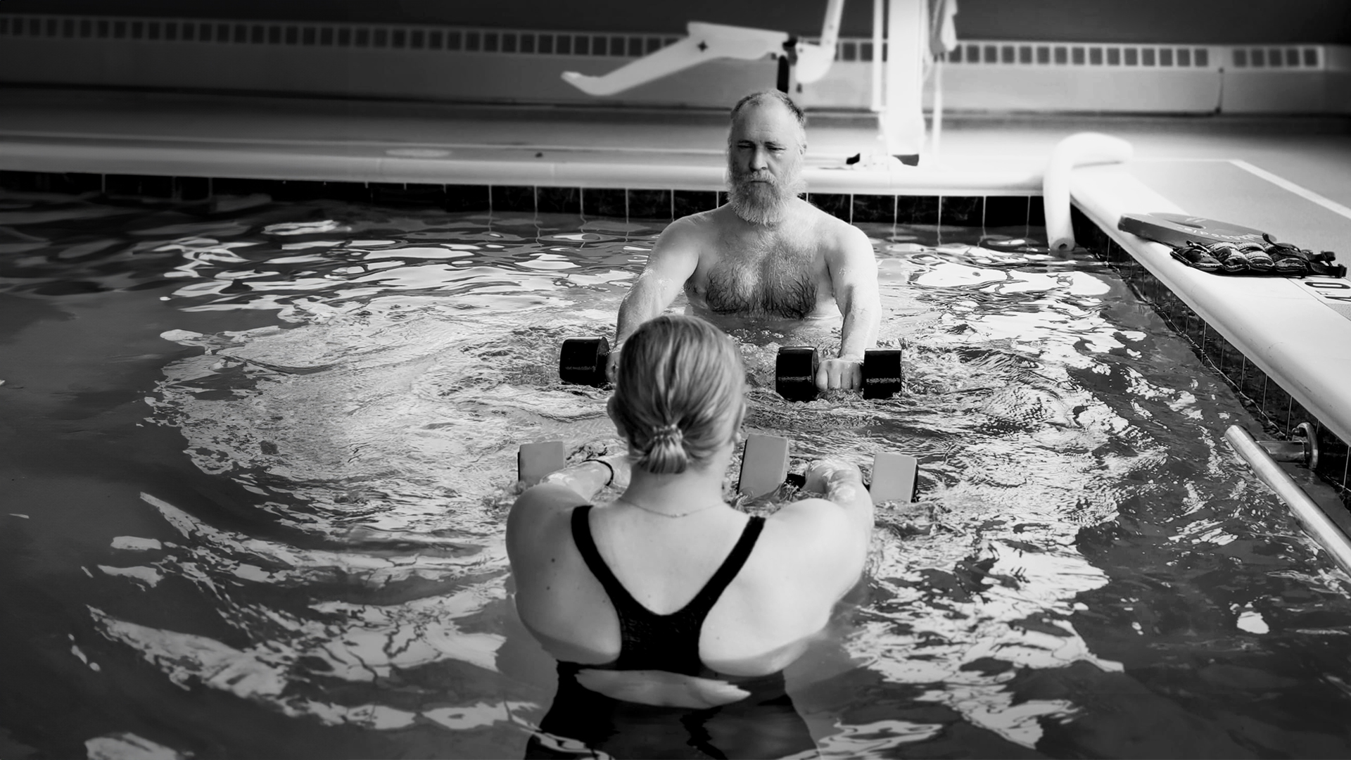 Residents exercising in a pool during aquatic therapy
