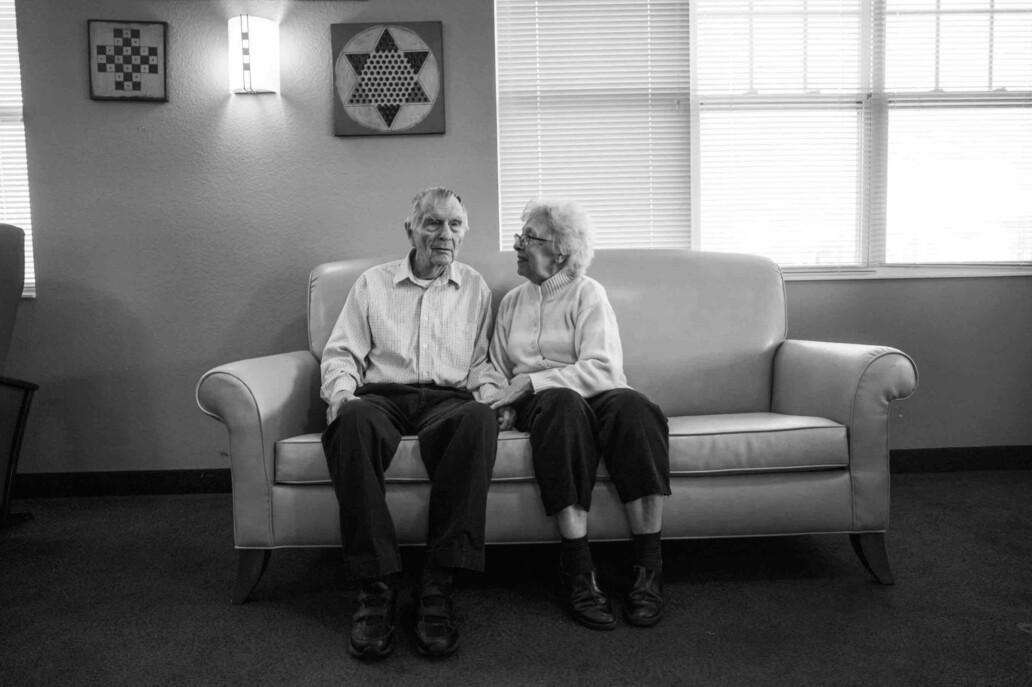 Elderly couple sitting together on a sofa