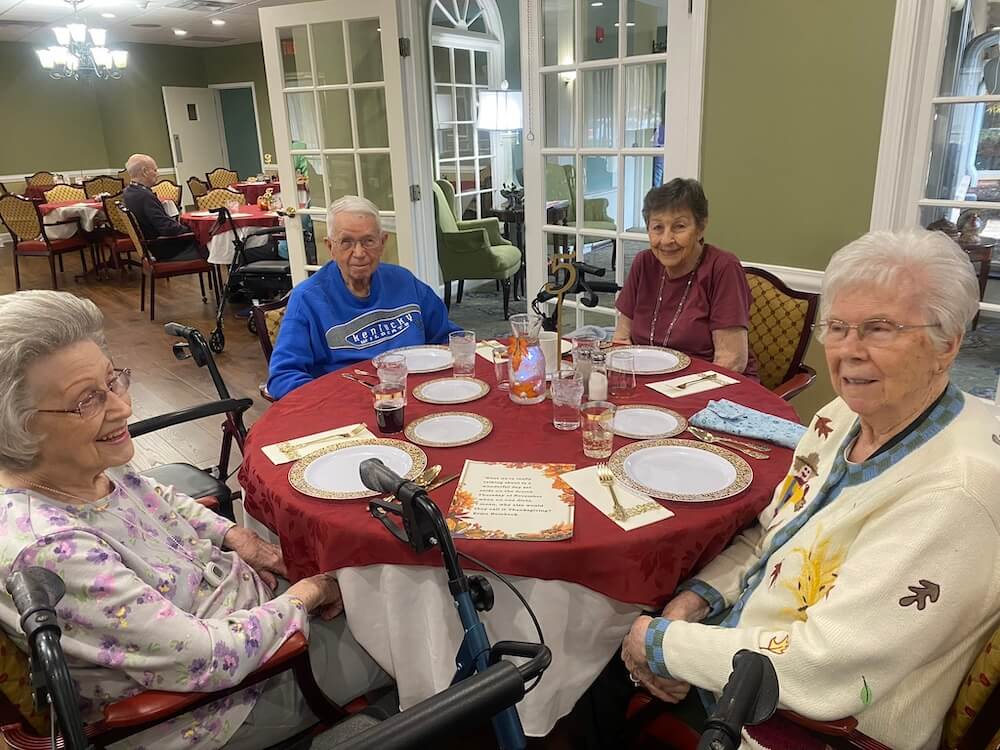 Residents enjoying a meal together in the dining room