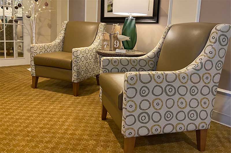 Two patterned chairs in a cozy interior space