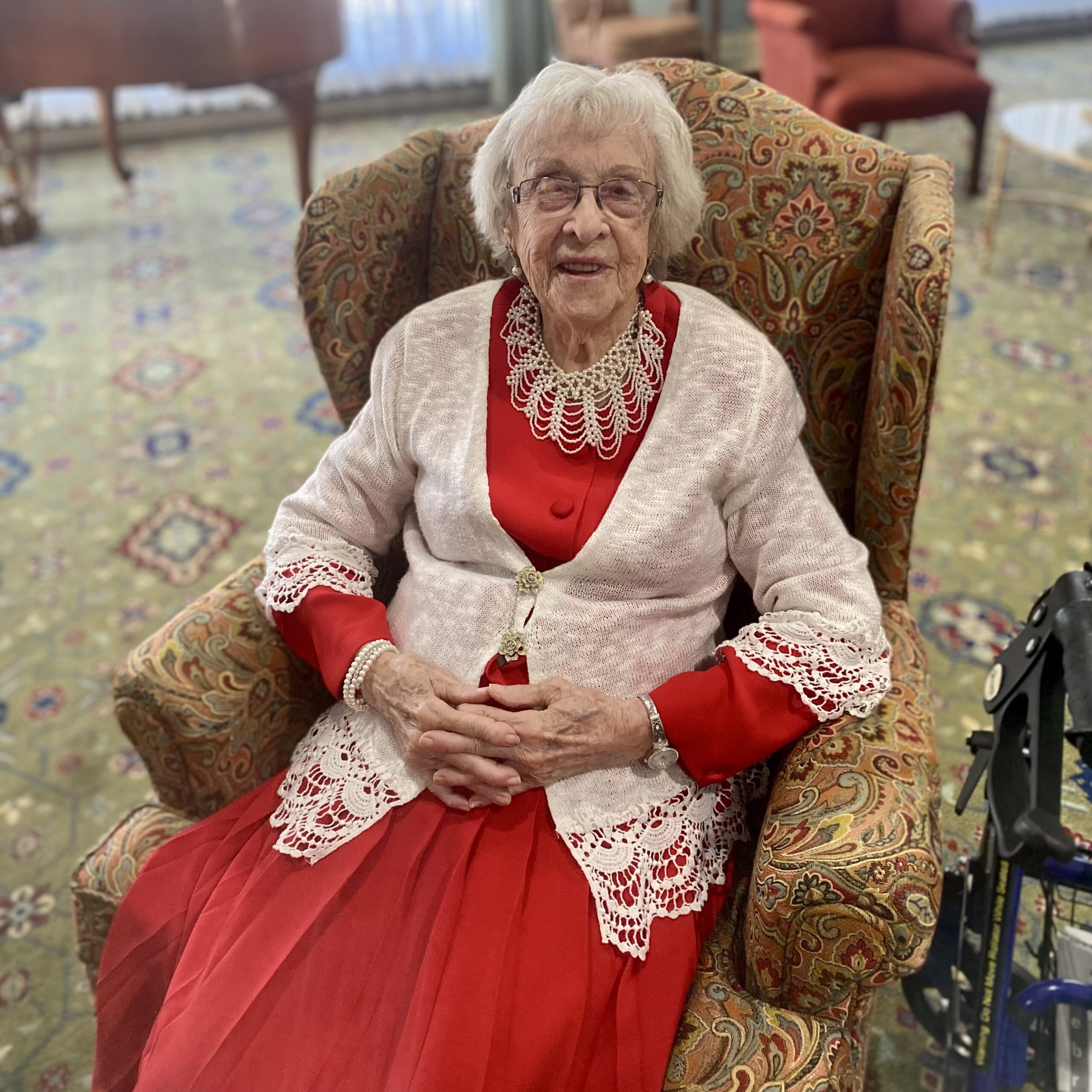 Resident sitting in a chair in a cozy common area