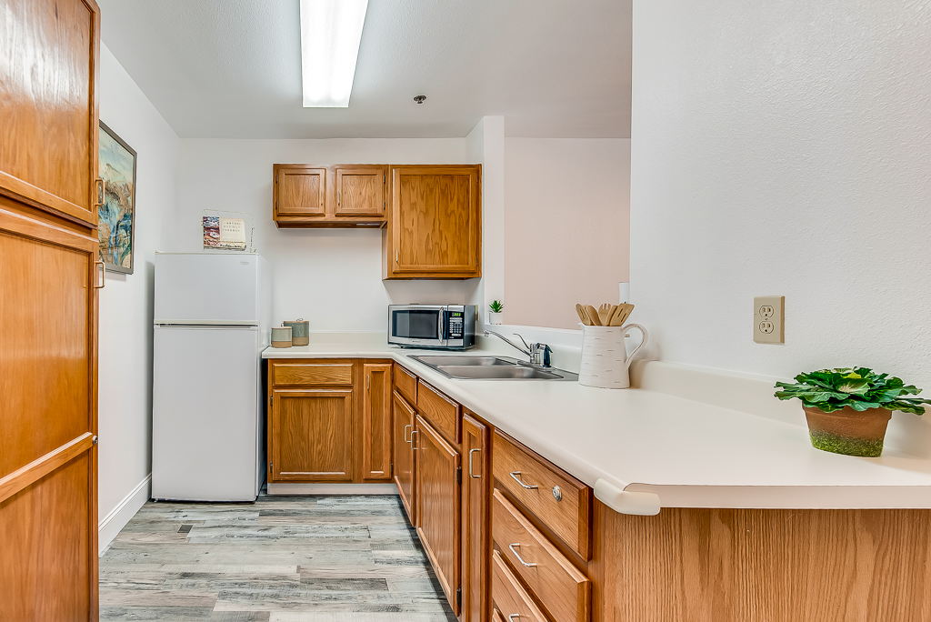 Interior view of a kitchen space with cabinets and appliances