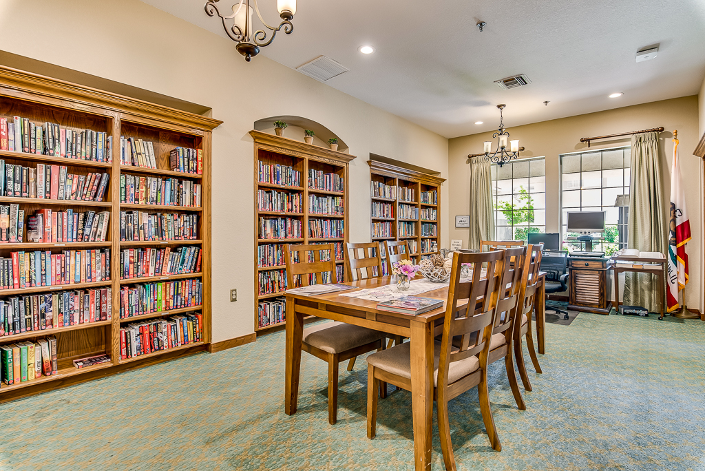 Interior common area with bookshelves and dining table