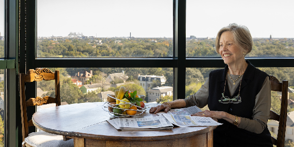 Resident enjoying a meal with a city view