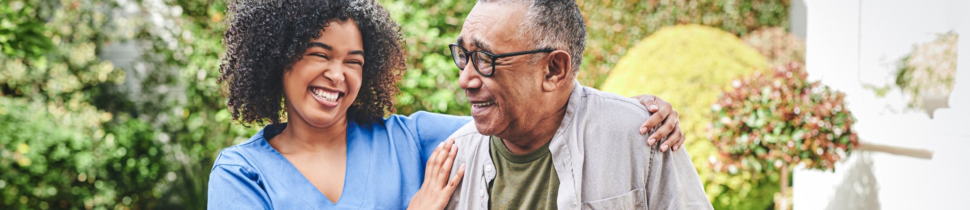 Resident and caregiver enjoying time together outdoors
