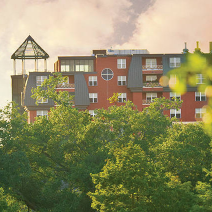 Exterior view of a senior living facility surrounded by trees