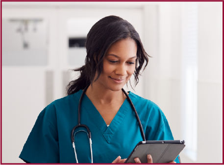 Nurse using a tablet in a bright interior space