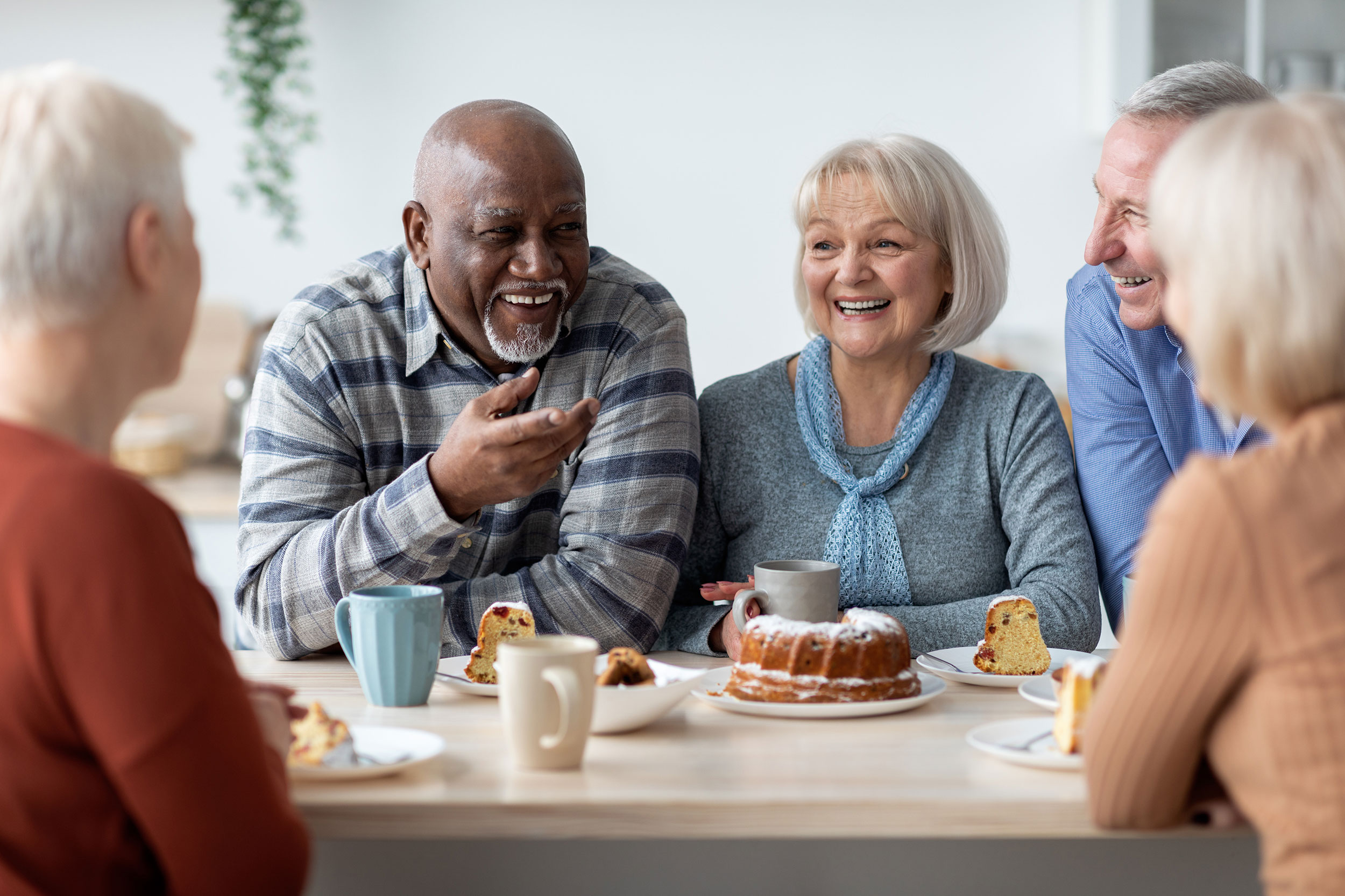 Residents enjoying a social gathering with dessert