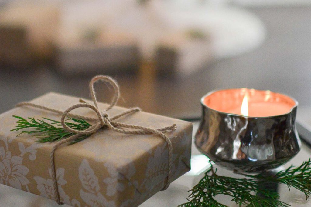 Decorative gift box and candle on a table