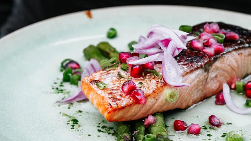 A beautifully plated salmon dish with garnish