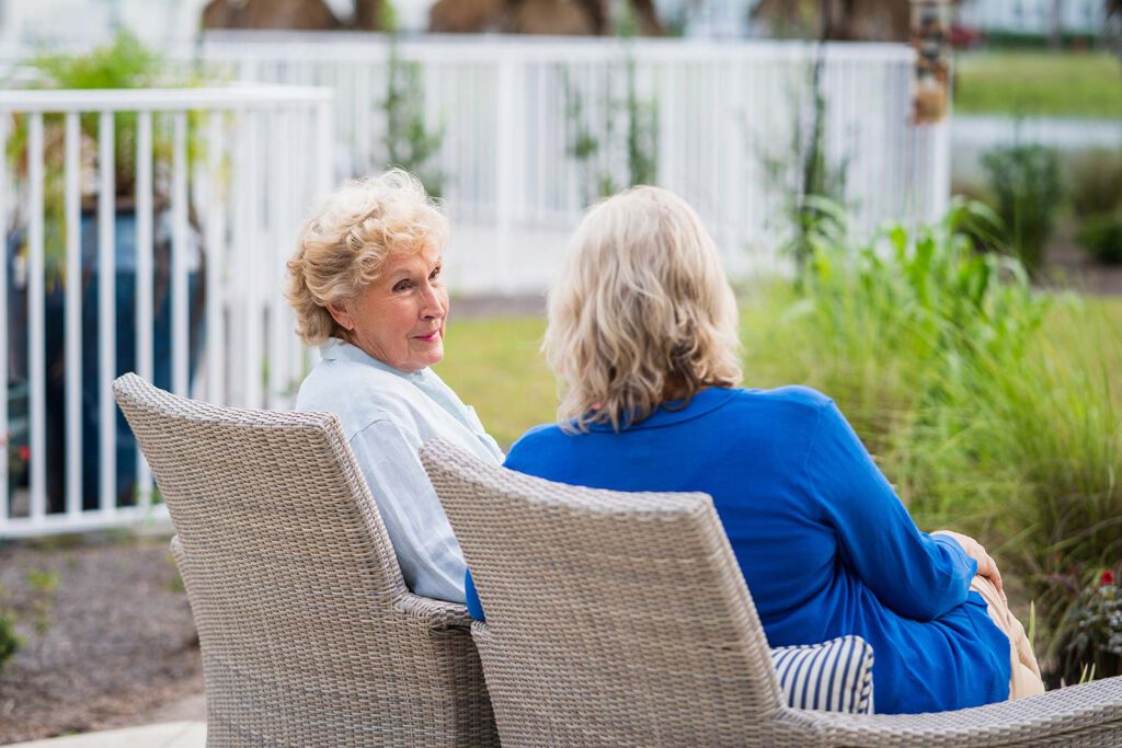 Two women chatting in a garden setting