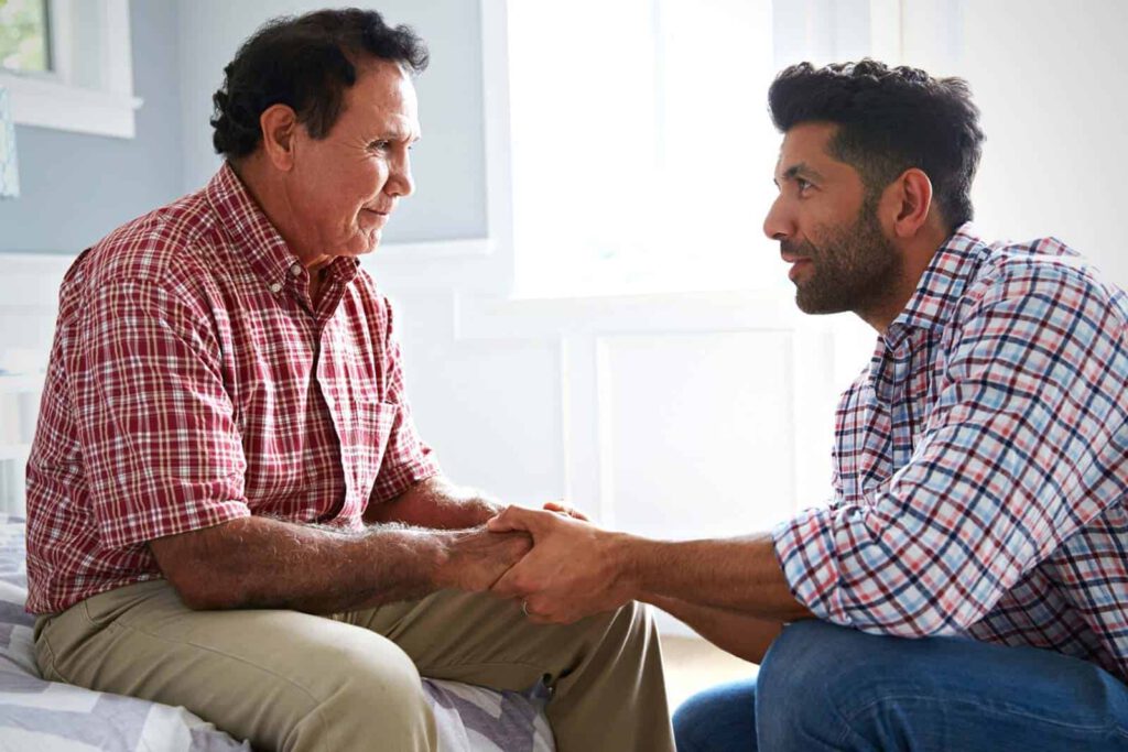 A senior man and a caregiver engaging in conversation