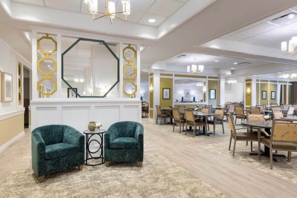 Bright dining area with green chairs and tables