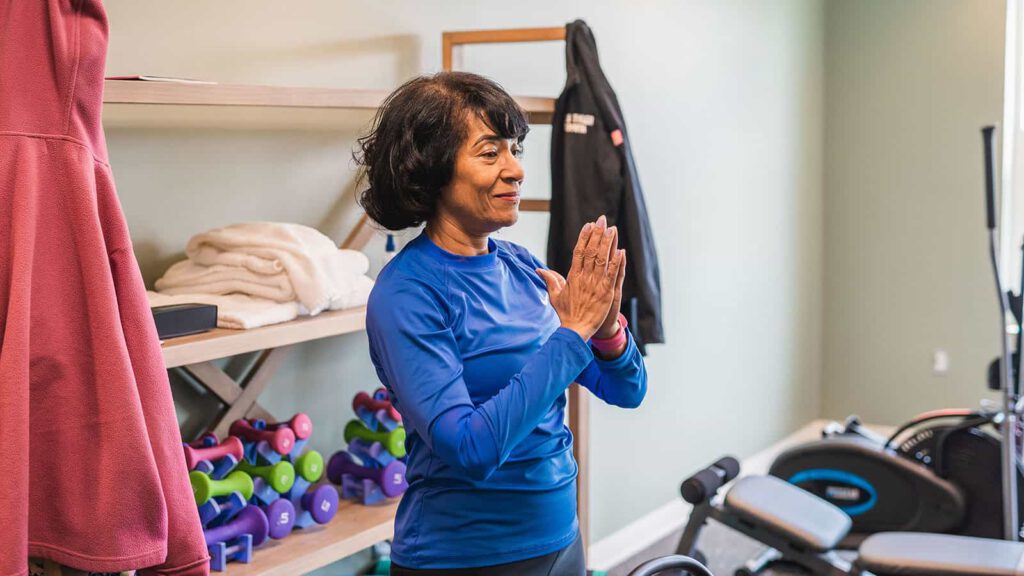 A woman practicing yoga in a fitness space