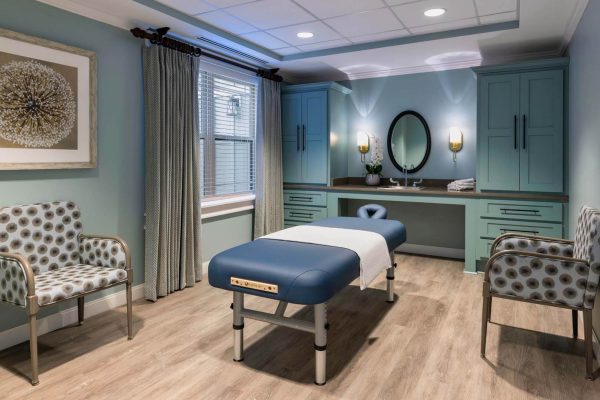 Interior massage therapy room with furniture and decor
