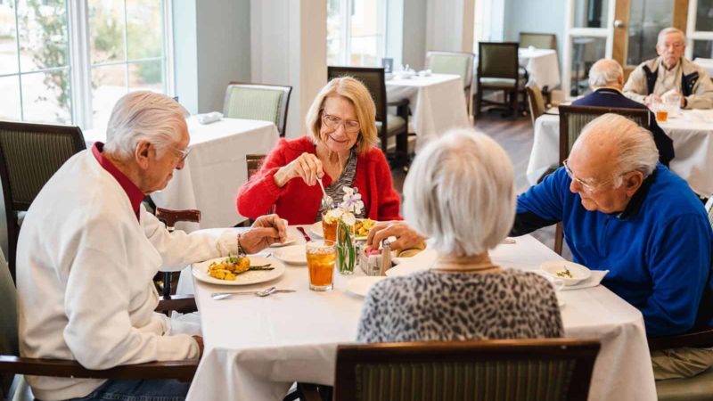 Residents enjoying a meal together in the dining room