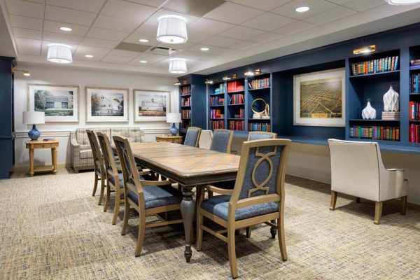 Interior view of a common area with seating and bookshelves