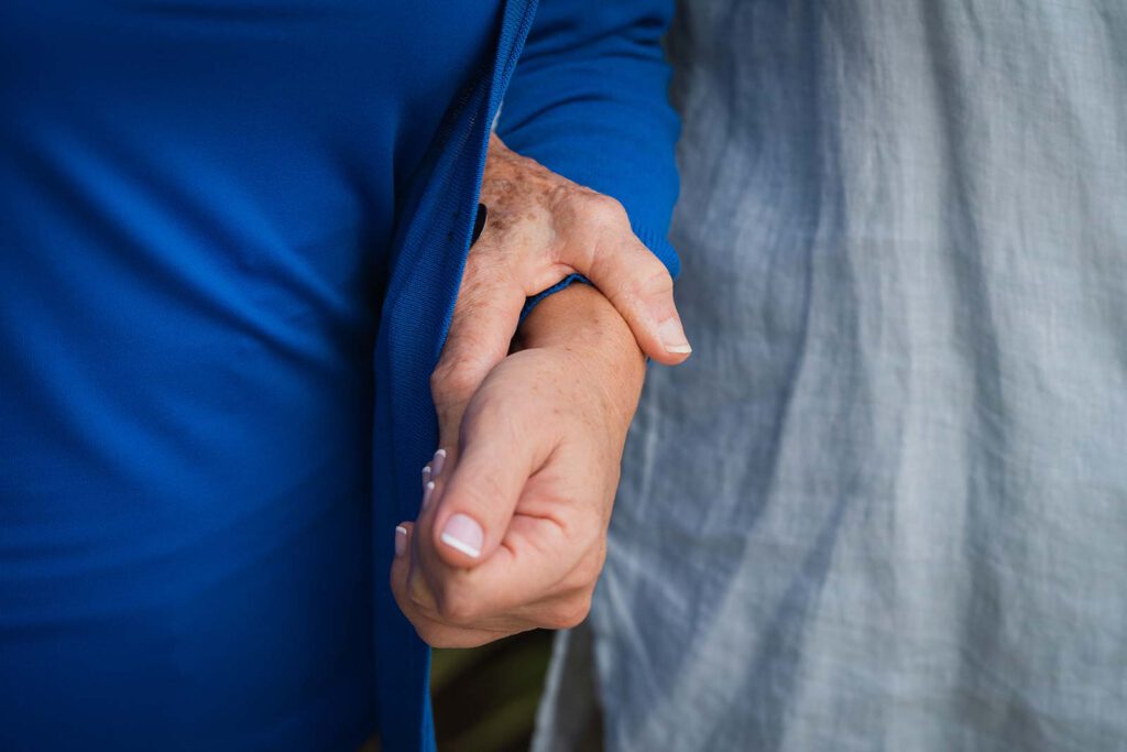 Close-up of two hands holding each other