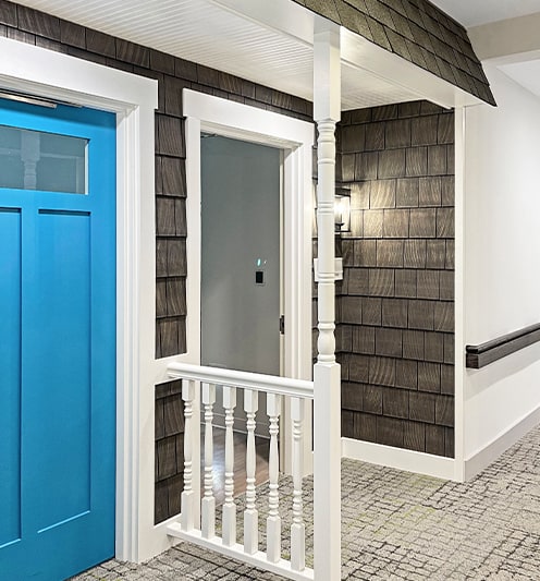 Interior hallway with blue door and decorative wall