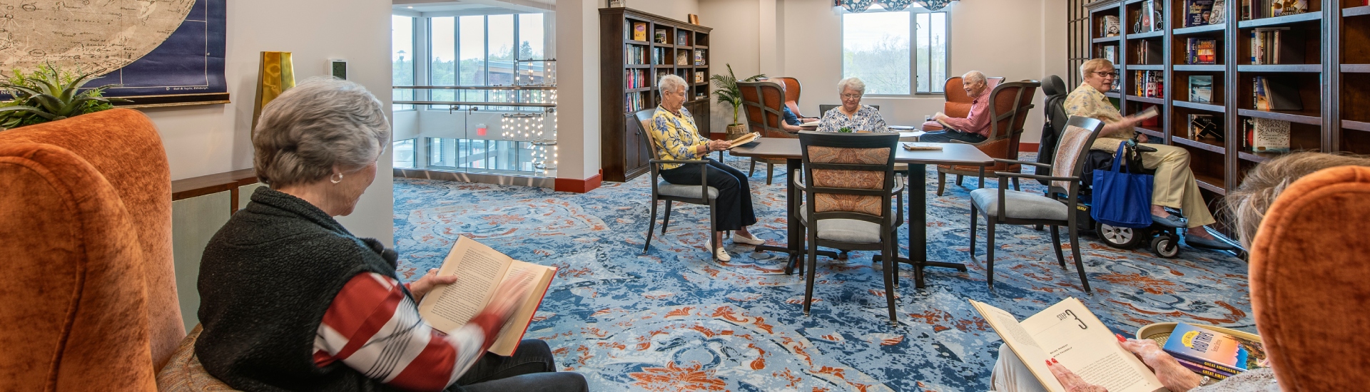 Residents reading in a cozy common area