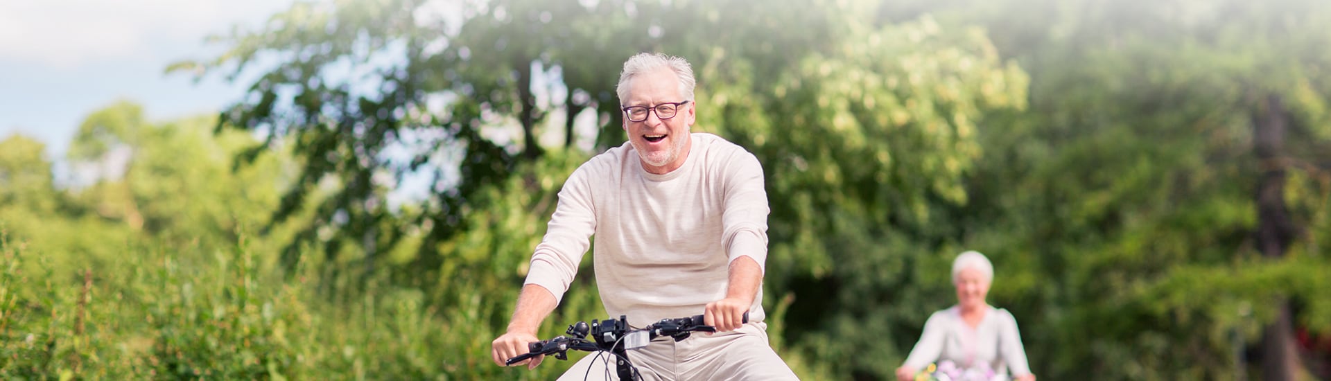 Seniors enjoying a bike ride in a park