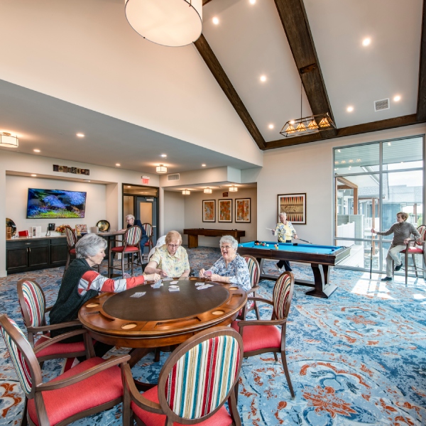 Residents engaged in a card game in a common area