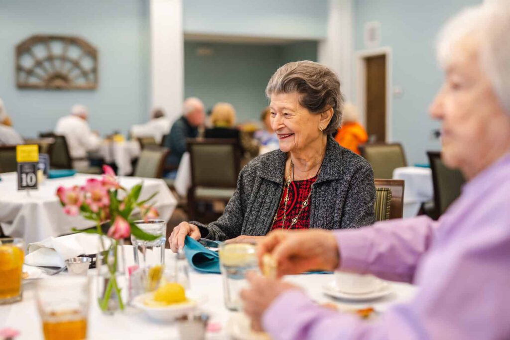Residents enjoying a meal together in a dining room