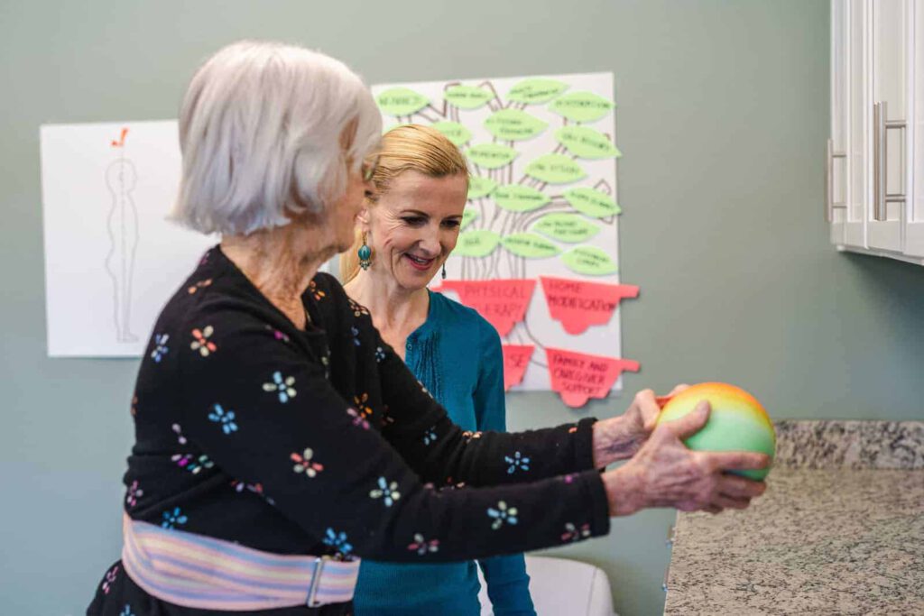 Resident engaging in a physical activity with staff assistance