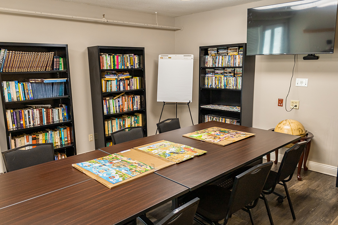 Interior view of a meeting room with bookshelves and a table
